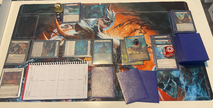 Codex of the Broken Chain: Challenger Edition in landscape orientation on Flesh and Blood playmat, fitting neatly between zones during active gameplay.